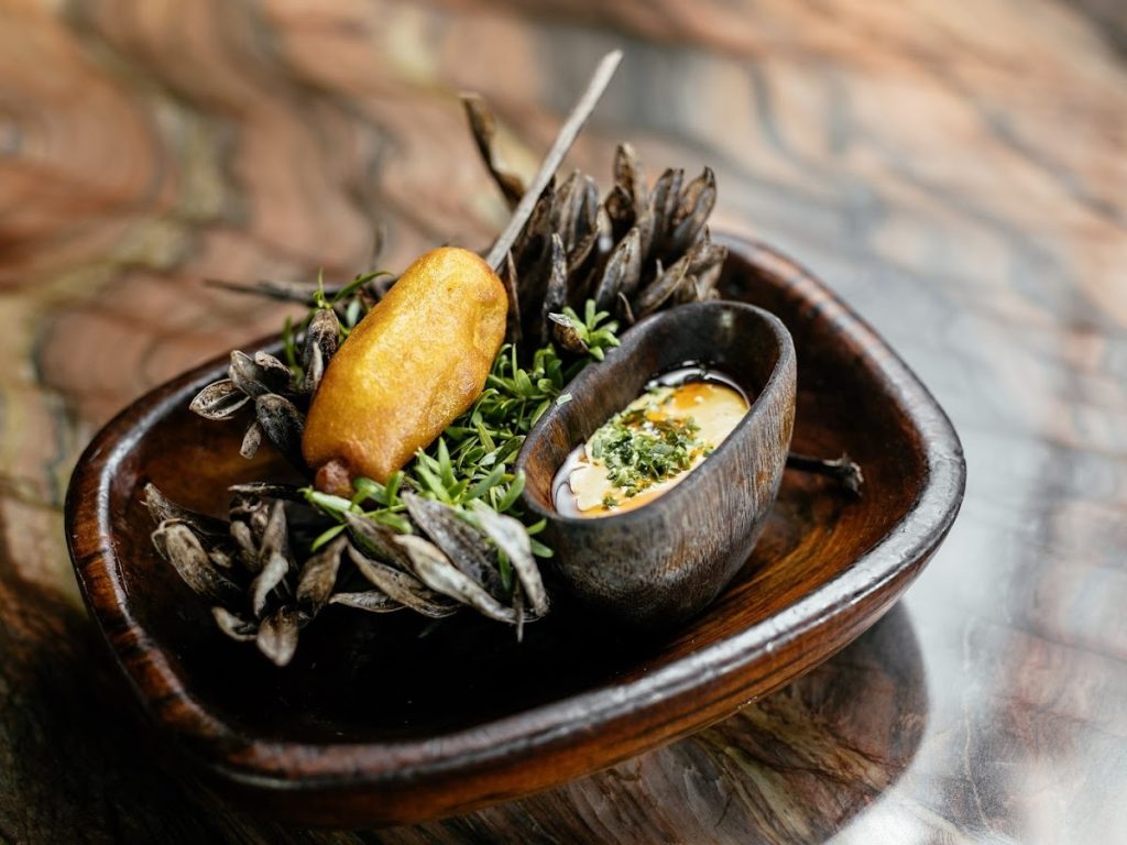 A plated entrée on a stone dish